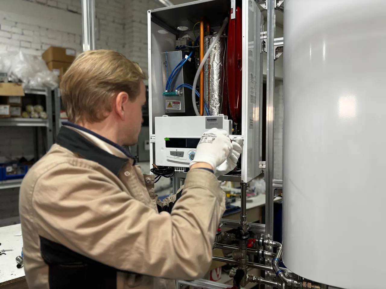 Technician at a wall-mounted tankless unit